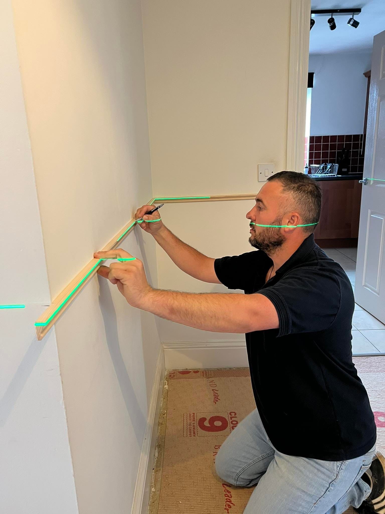 Carpenter measuring and marking timber on site